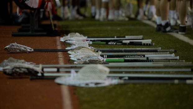 Lacrosse sticks on the ground.